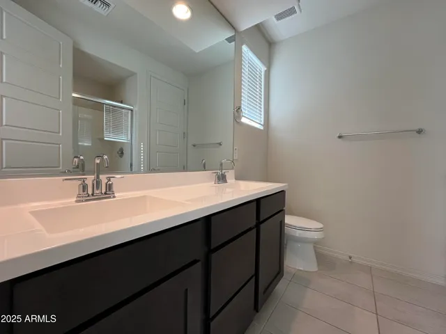 a bathroom with a sink toilet and mirror