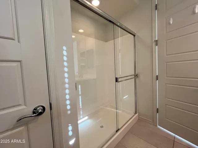 a bathroom with a glass shower door