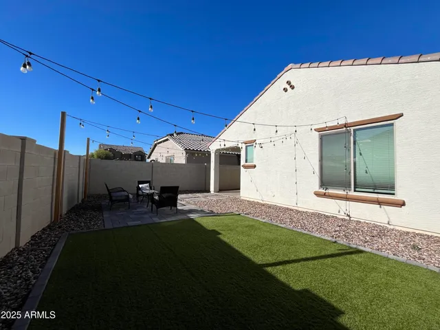 a view of a house with backyard and porch