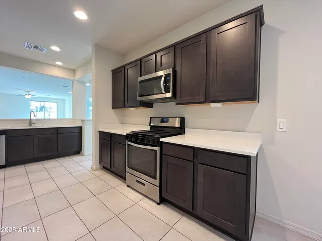 a kitchen with stainless steel appliances a sink stove and cabinets
