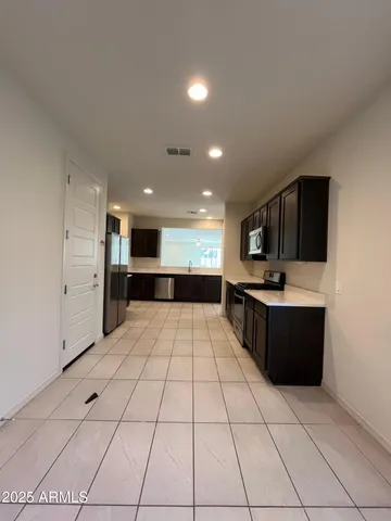 a large white kitchen with a large window