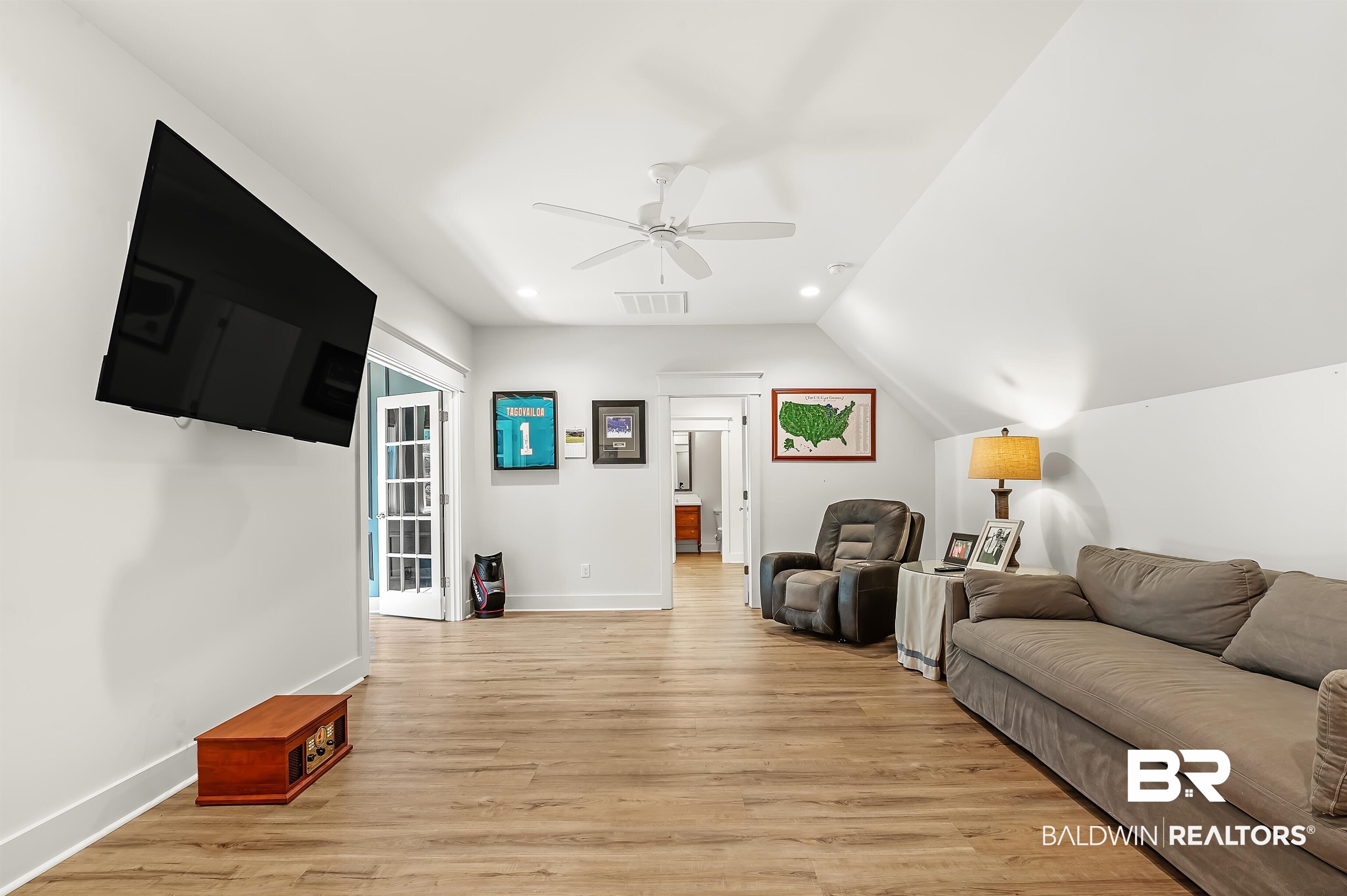 27888 Oakachoy Loop Daphne, AL 36526 - Photo 41 of 65 Living room with light wood finished floors, lofted ceiling, baseboards, visible vents, and ceiling fan