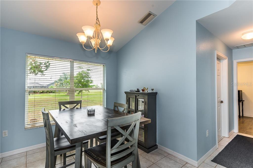 7557 South Blue Sage Punta Gorda, FL 33955 - Photo 13 of 28 a view of a dining room with furniture window and outside view