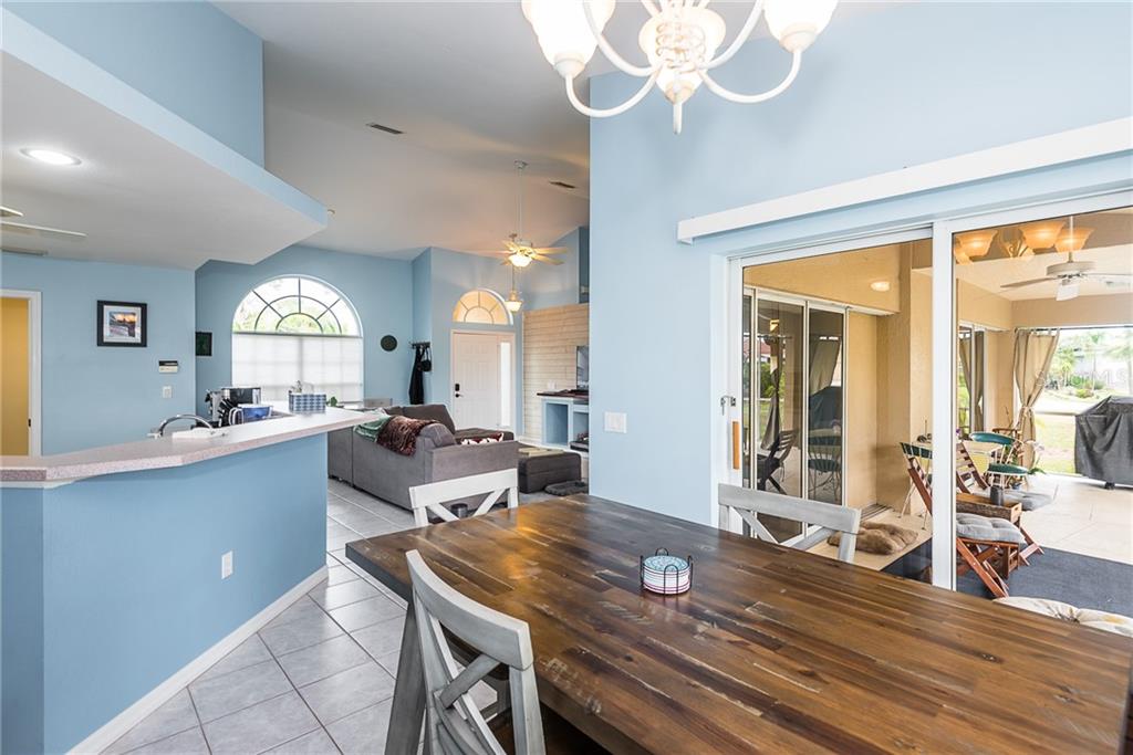 7557 South Blue Sage Punta Gorda, FL 33955 - Photo 14 of 28 a kitchen with a table chairs and cabinets
