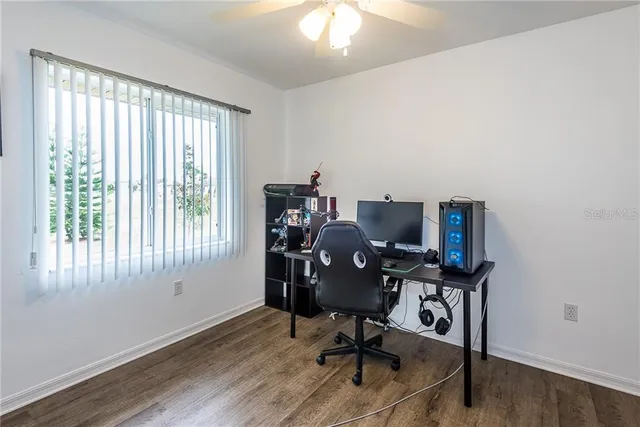 a view of a workspace with furniture and a window