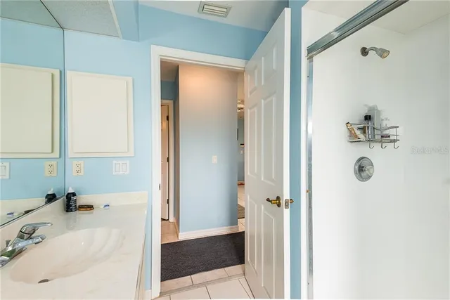 a bathroom with a tub sink and shower