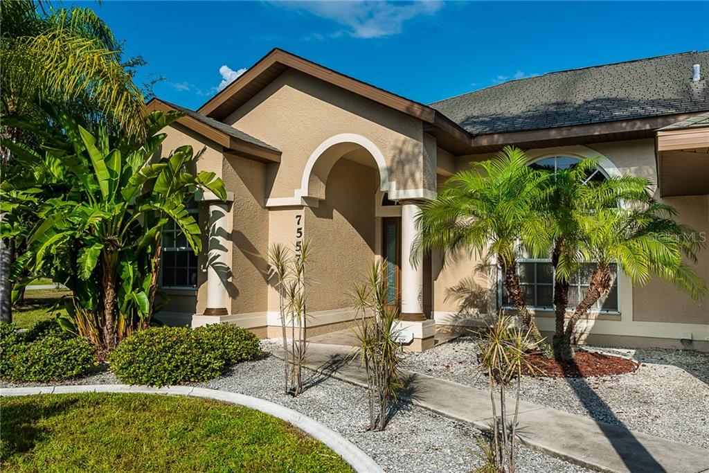 7557 South Blue Sage Punta Gorda, FL 33955 - Photo 2 of 28 a front view of a house with garden