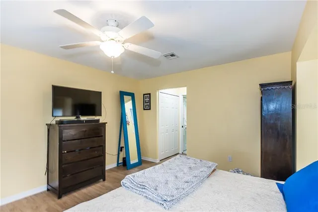 a bedroom with a bed and a dresser