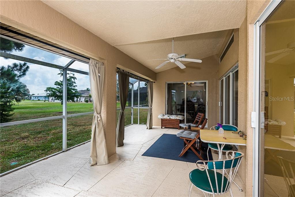 7557 South Blue Sage Punta Gorda, FL 33955 - Photo 28 of 28 a living room with patio furniture and a floor to ceiling window