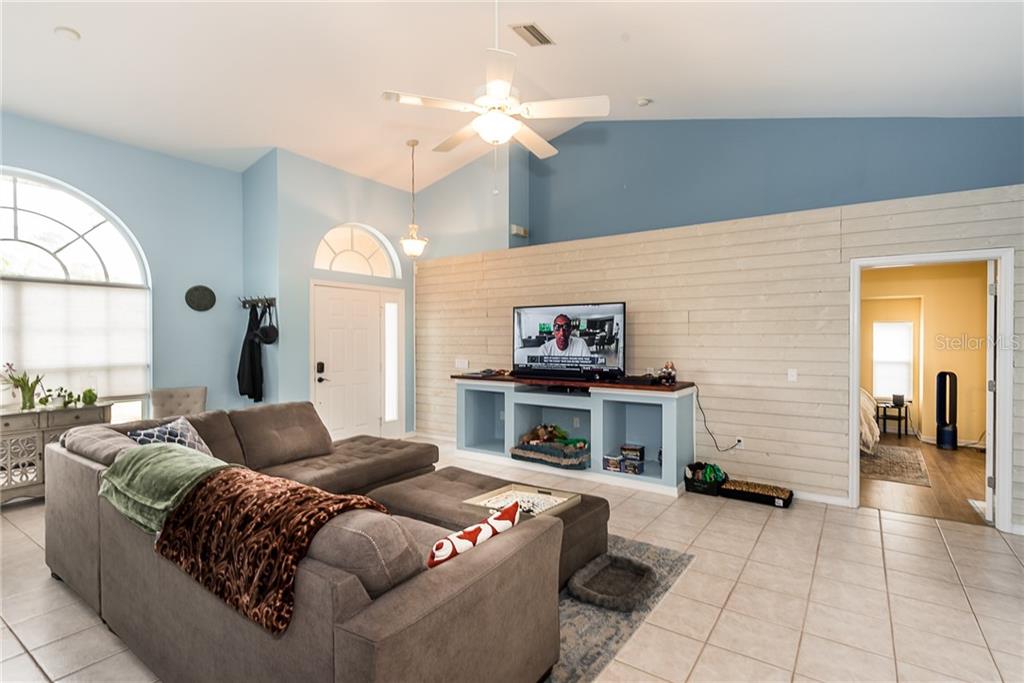 7557 South Blue Sage Punta Gorda, FL 33955 - Photo 5 of 28 a living room with furniture and a fireplace