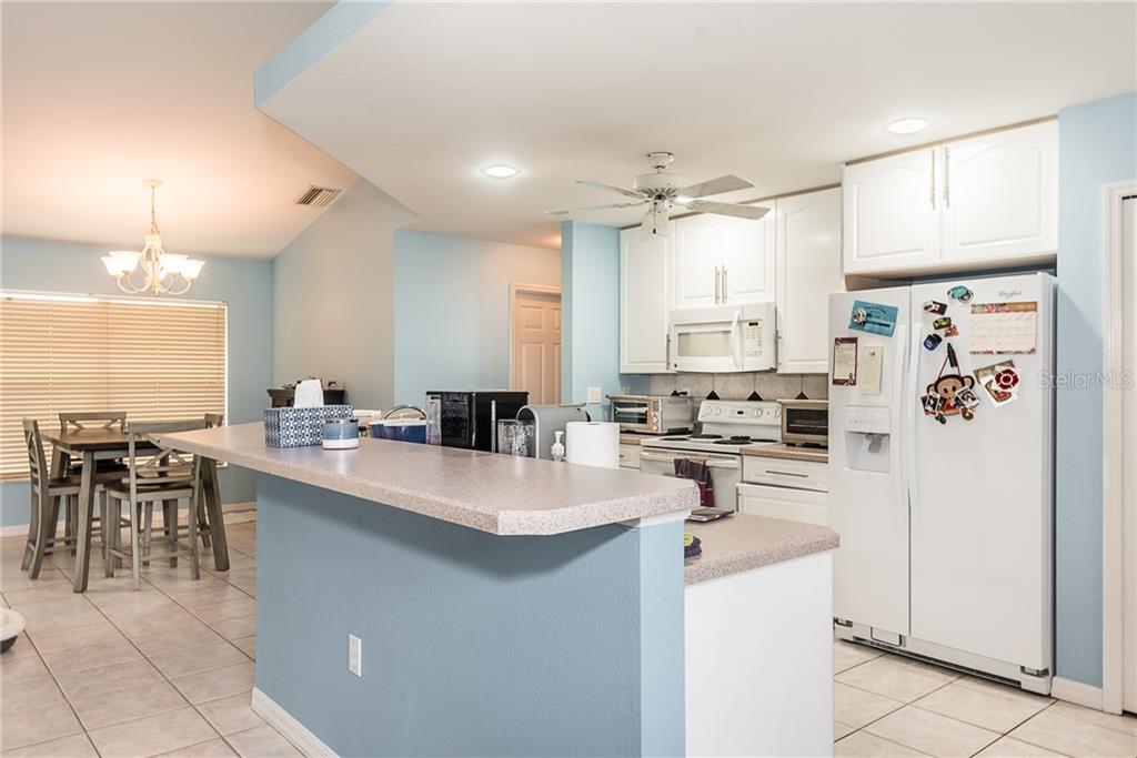 7557 South Blue Sage Punta Gorda, FL 33955 - Photo 7 of 28 a kitchen with a sink a stove a refrigerator and cabinets