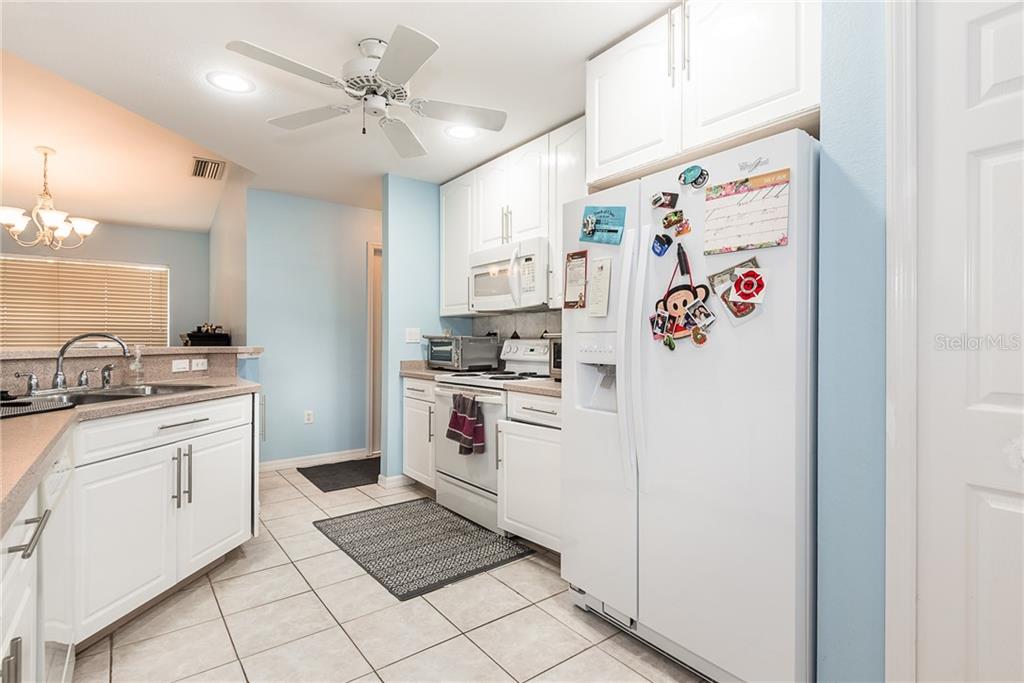 7557 South Blue Sage Punta Gorda, FL 33955 - Photo 8 of 28 a kitchen with a refrigerator and a sink