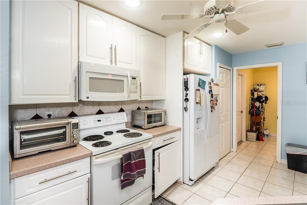 7557 South Blue Sage Punta Gorda, FL 33955 - Photo 10 of 28 a kitchen with a stove cabinets and refrigerator