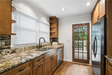 a spacious bathroom with a granite countertop sink and a window