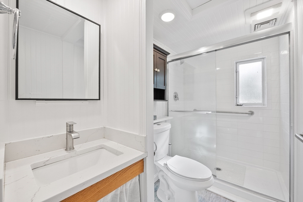 48 River Road Norfolk, MA 02056 - Photo 15 of 42 a bathroom with a sink toilet vanity and shower