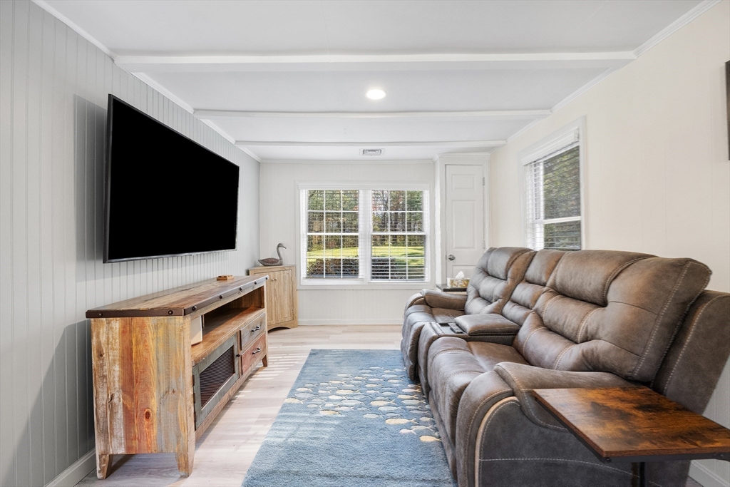 48 River Road Norfolk, MA 02056 - Photo 19 of 42 a living room with furniture and a flat screen tv