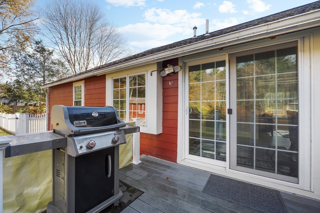 48 River Road Norfolk, MA 02056 - Photo 8 of 42 a view of a deck with wooden floor and a fireplace