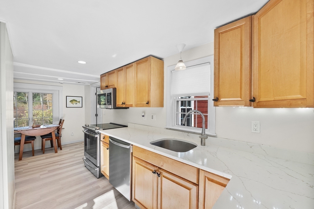 48 River Road Norfolk, MA 02056 - Photo 10 of 42 a kitchen that has a sink and a stove in it