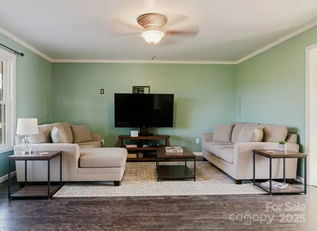 a view of room with wooden floor and fan