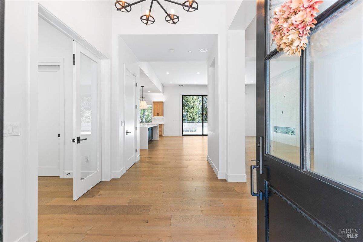 794 Los Olivos Road Santa Rosa, CA 95404 - Photo 11 of 59 a view of a hallway with wooden floor and staircase
