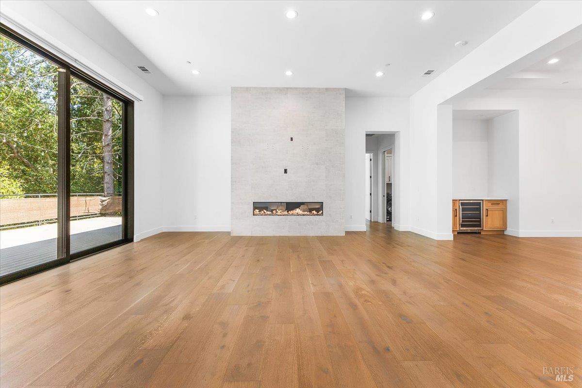 794 Los Olivos Road Santa Rosa, CA 95404 - Photo 17 of 59 a view of an empty room with wooden floor and a window