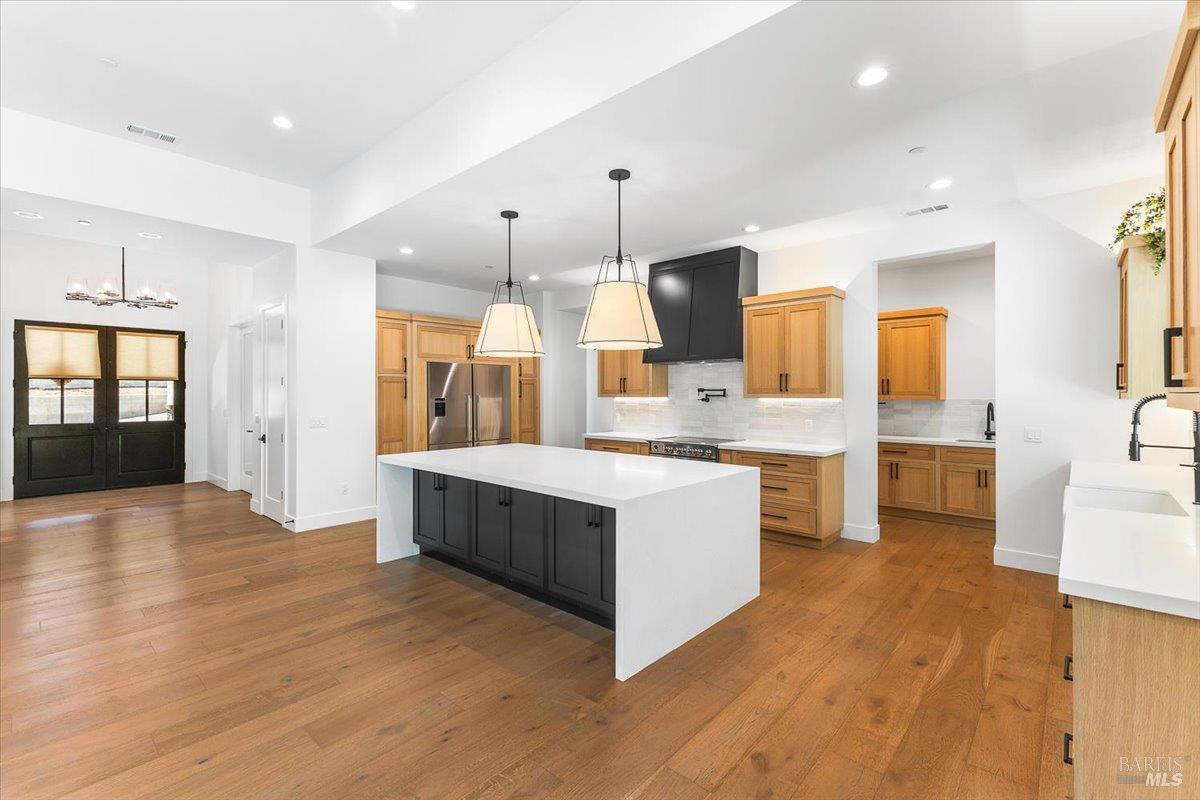 794 Los Olivos Road Santa Rosa, CA 95404 - Photo 20 of 59 a large kitchen with a lot of counter space and wooden floor