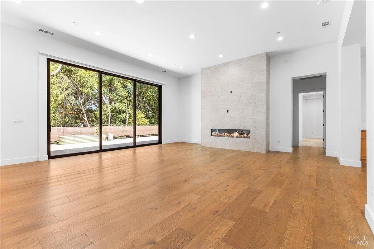 794 Los Olivos Road Santa Rosa, CA 95404 - Photo 25 of 59 a view of an empty room with a window and wooden floor