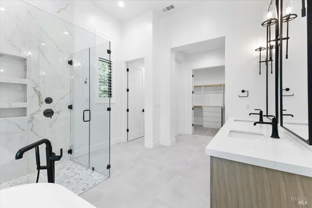 a view of walk in closet with empty racks