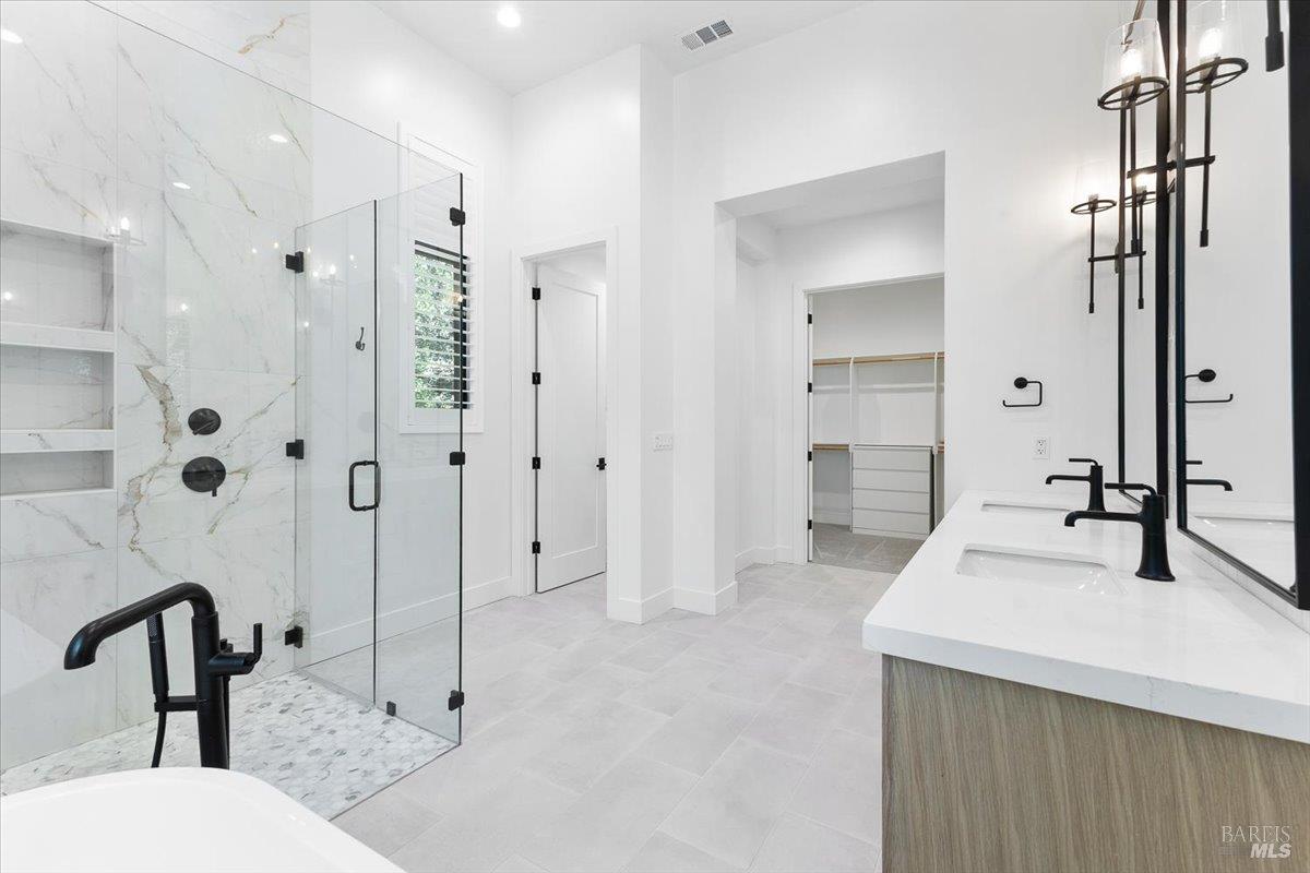 794 Los Olivos Road Santa Rosa, CA 95404 - Photo 25 of 59 a bathroom with a double vanity sink and mirror