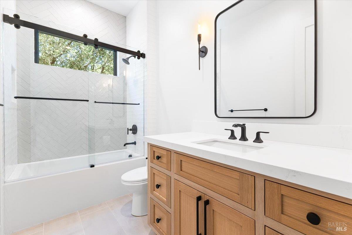 794 Los Olivos Road Santa Rosa, CA 95404 - Photo 34 of 59 a bathroom with a granite countertop sink a toilet and a bathtub