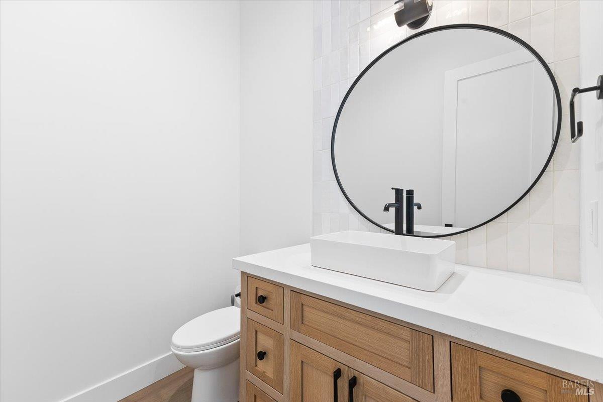 794 Los Olivos Road Santa Rosa, CA 95404 - Photo 37 of 59 a bathroom with a sink mirror and toilet