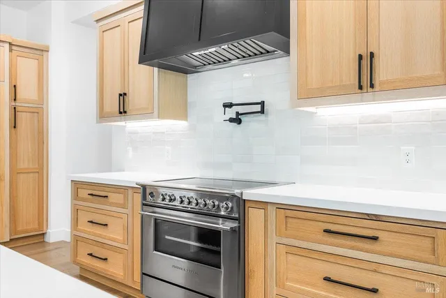 a stove top oven sitting inside of a kitchen