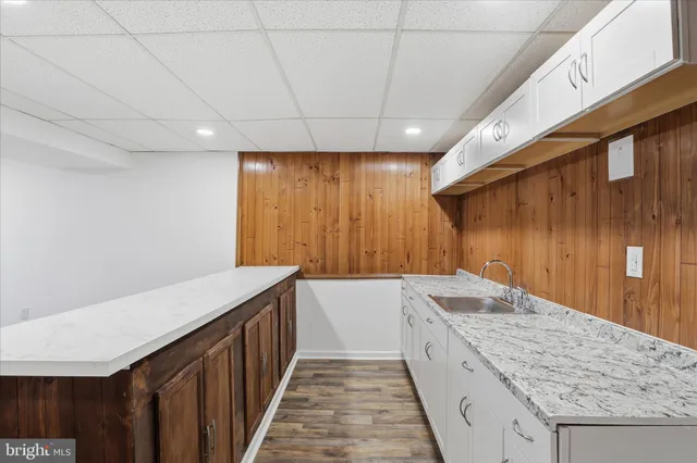 a spacious bathroom with a granite countertop sink and a bathtub