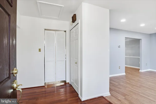 a view of hallway with wooden floor