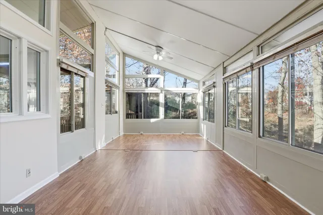 a view of an entryway with wooden floor and windows