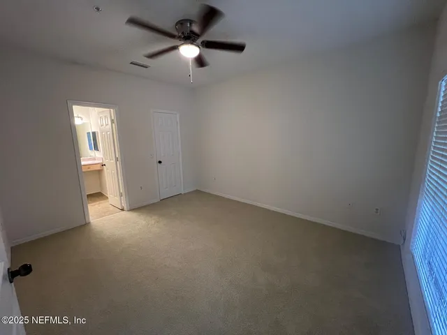 an empty room with a empty space and a ceiling fan