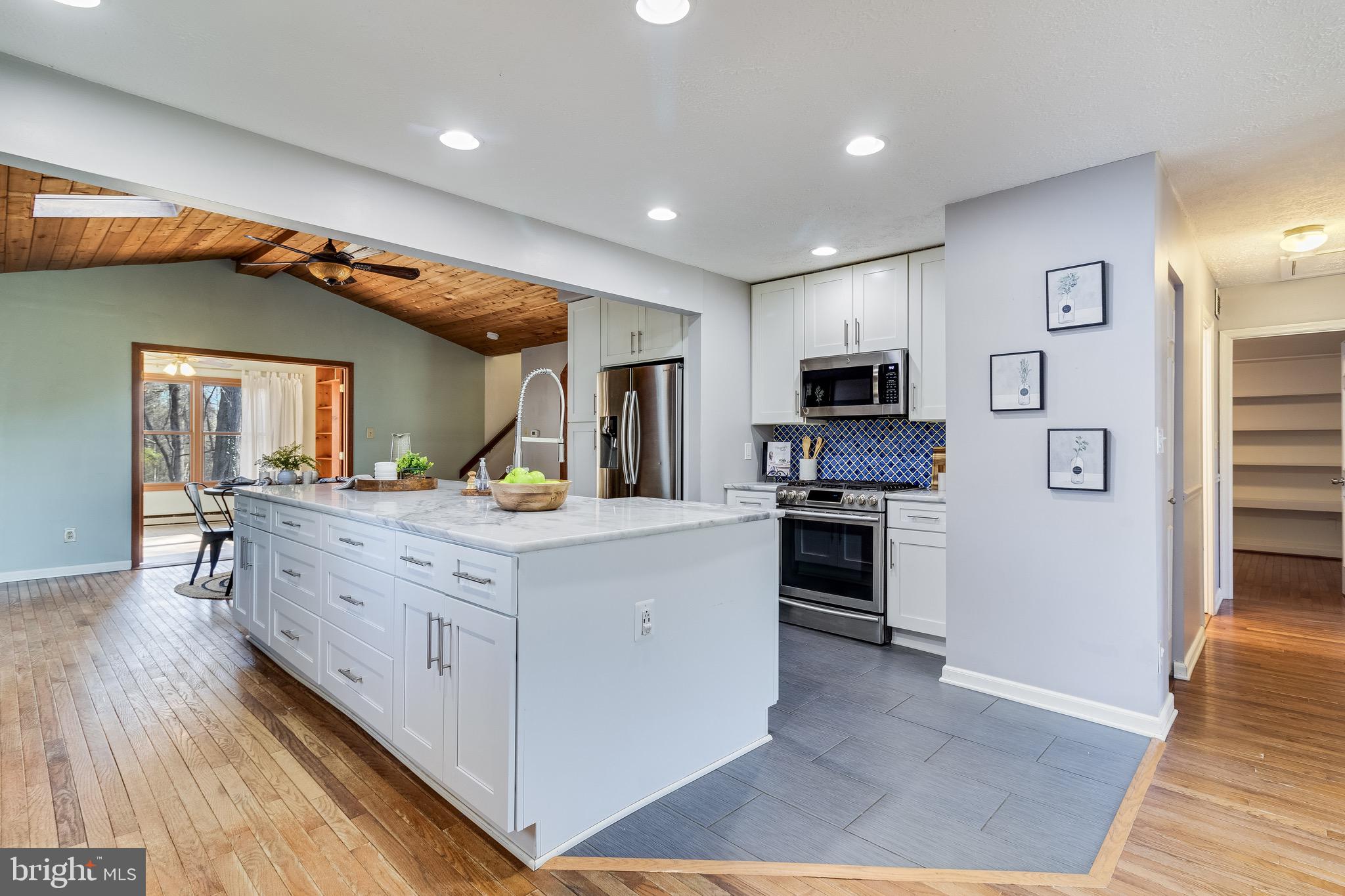 5131 Solomons Island Road Huntingtown, MD 20639 - Photo 13 of 42 a kitchen with stainless steel appliances granite countertop a stove a sink and a refrigerator