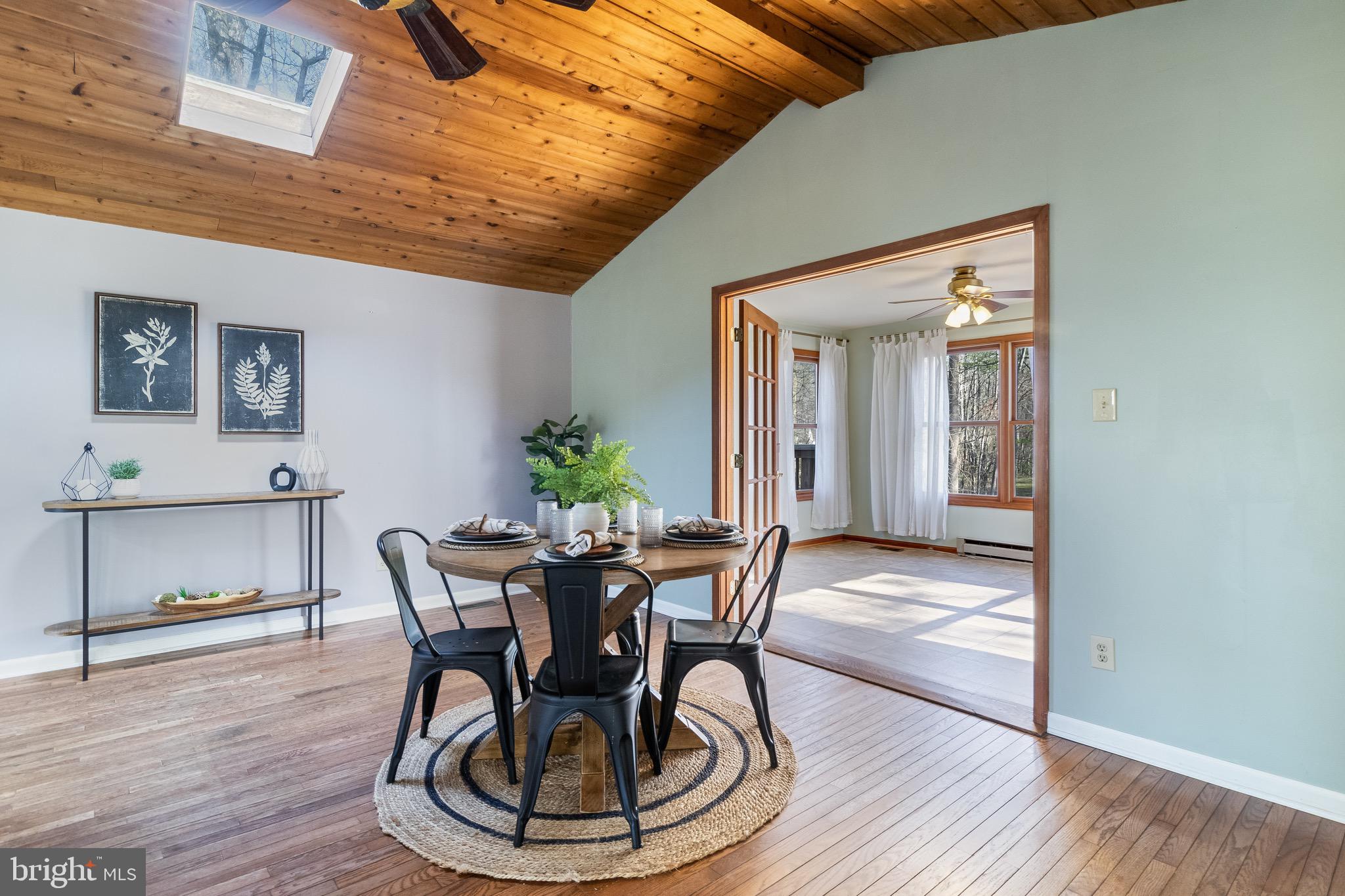 5131 Solomons Island Road Huntingtown, MD 20639 - Photo 16 of 42 a view of a dining room with furniture and wooden floor