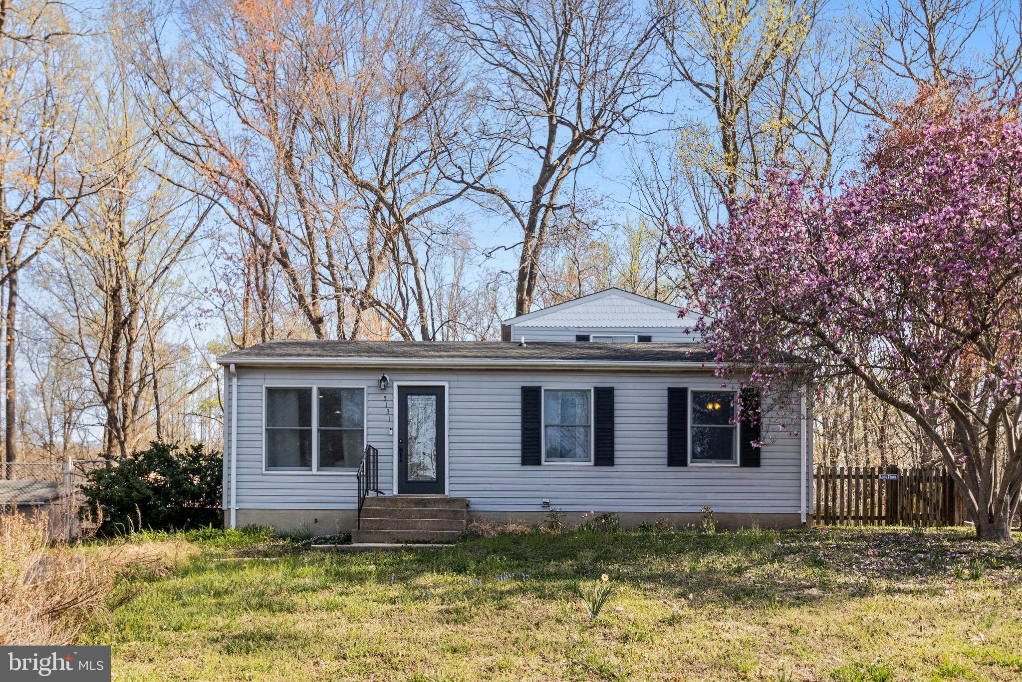 5131 Solomons Island Road Huntingtown, MD 20639 - Photo 2 of 42 a front view of a house with a yard table and chairs