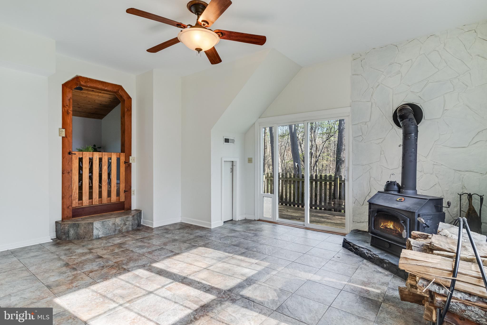 5131 Solomons Island Road Huntingtown, MD 20639 - Photo 22 of 42 a view of livingroom with furniture fireplace and window