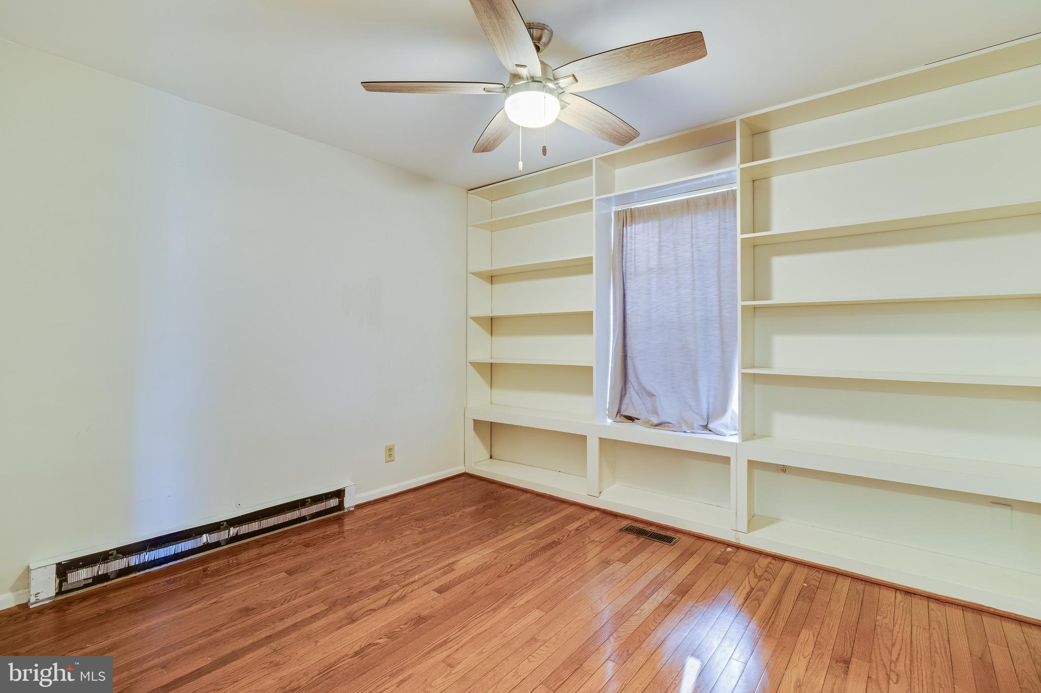 5131 Solomons Island Road Huntingtown, MD 20639 - Photo 27 of 42 a view of an empty room with a window and wooden floor