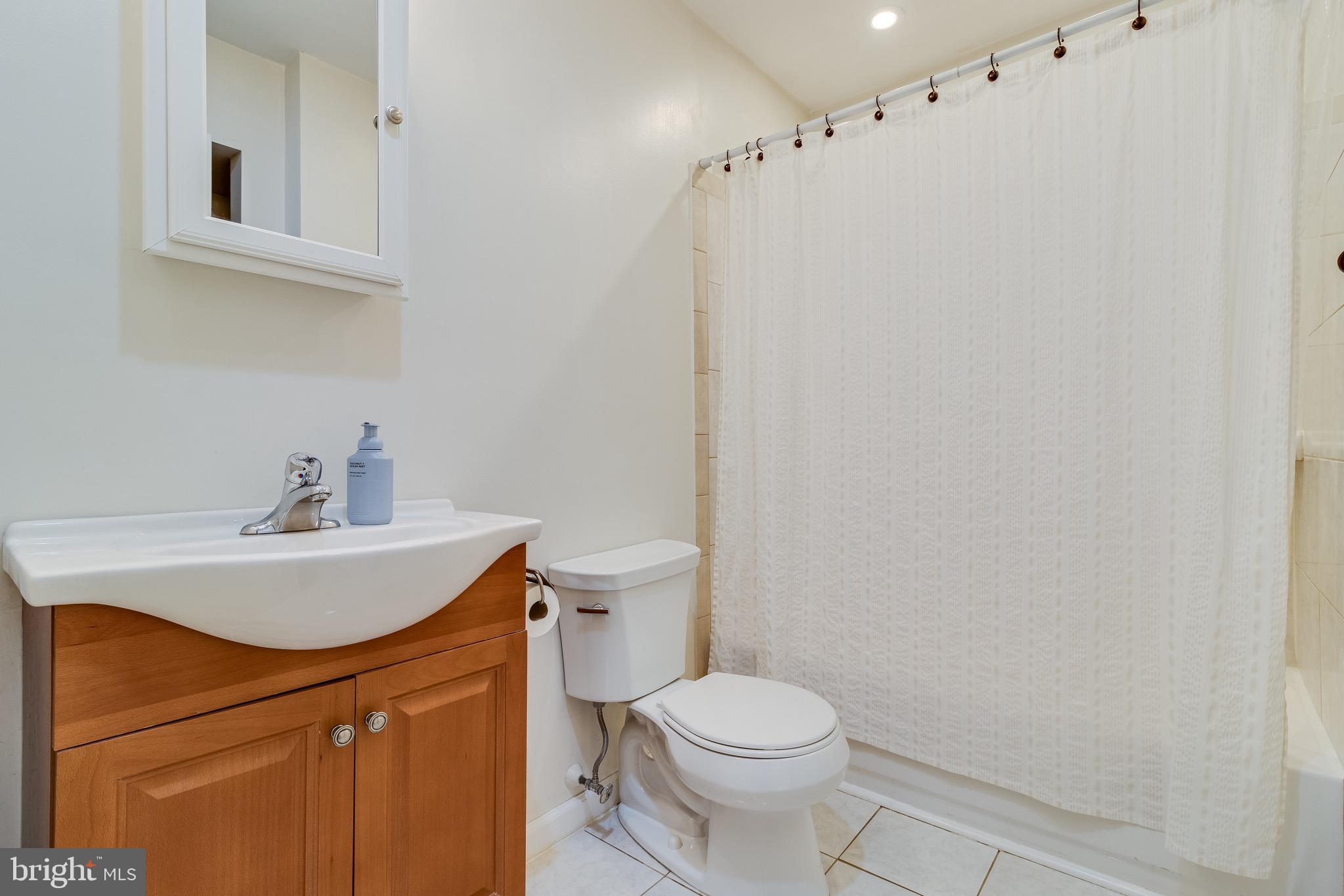 5131 Solomons Island Road Huntingtown, MD 20639 - Photo 29 of 42 a white toilet sitting next to a bathroom sink