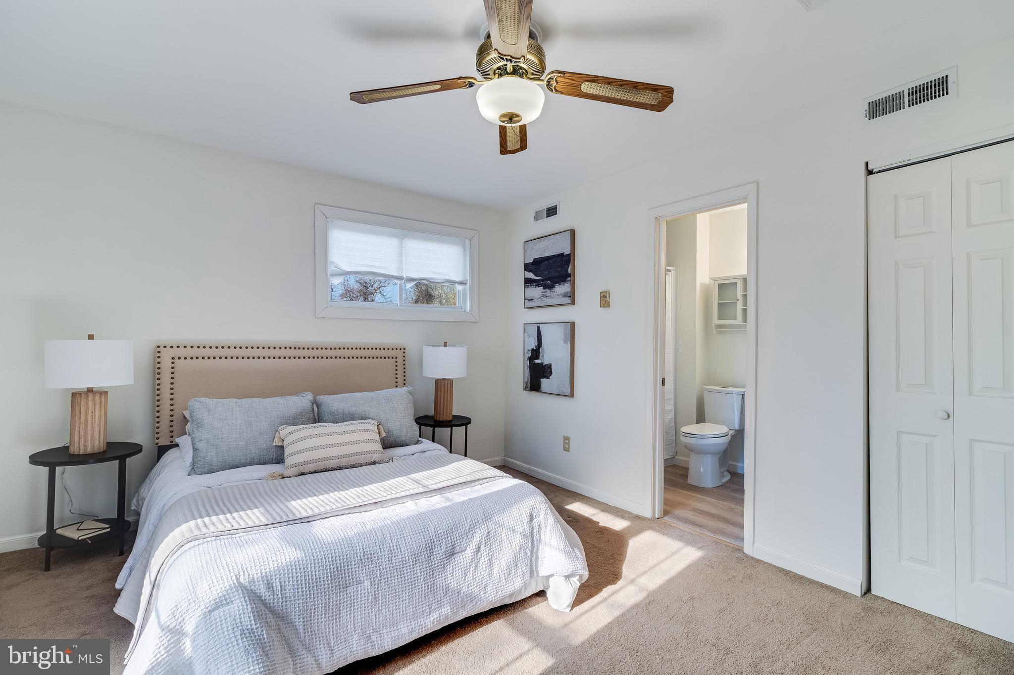 5131 Solomons Island Road Huntingtown, MD 20639 - Photo 31 of 42 a bedroom with a bed and a chandelier