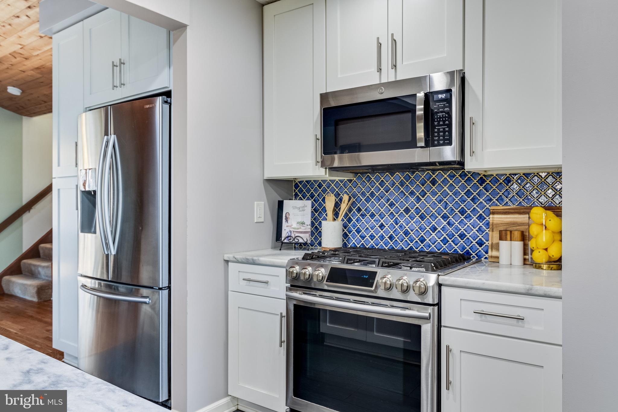 5131 Solomons Island Road Huntingtown, MD 20639 - Photo 8 of 42 a kitchen with stainless steel appliances white cabinets and a stove