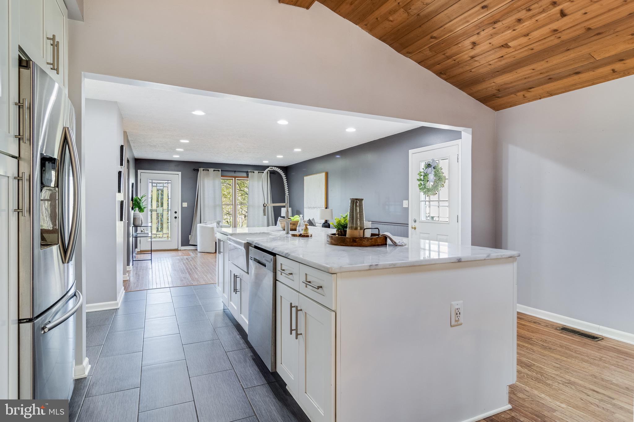 5131 Solomons Island Road Huntingtown, MD 20639 - Photo 10 of 42 a kitchen with stainless steel appliances granite countertop a sink and a refrigerator