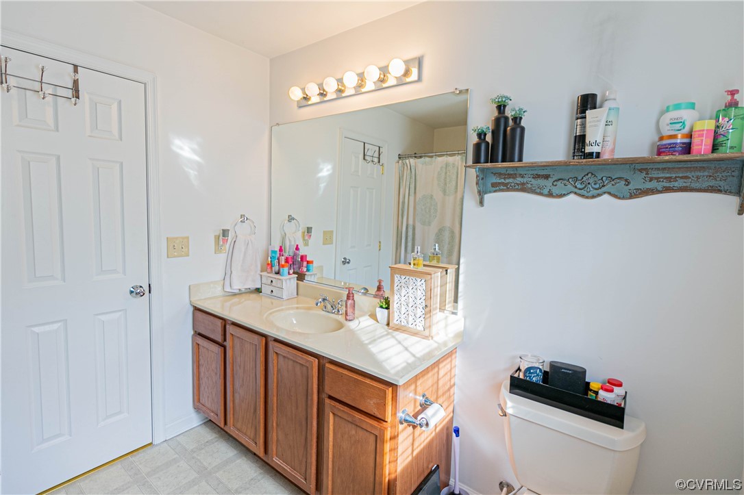 213 Cedar Ridge Drive Ruther Glen, VA 22546 - Photo 15 of 50 Bathroom with tile floors, toilet, and vanity