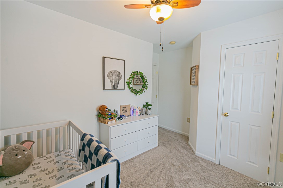 213 Cedar Ridge Drive Ruther Glen, VA 22546 - Photo 18 of 50 Carpeted bedroom featuring a crib and ceiling fan