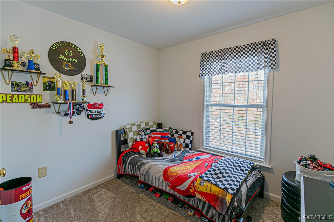 213 Cedar Ridge Drive Ruther Glen, VA 22546 - Photo 20 of 50 a bedroom with a bed and a chandelier