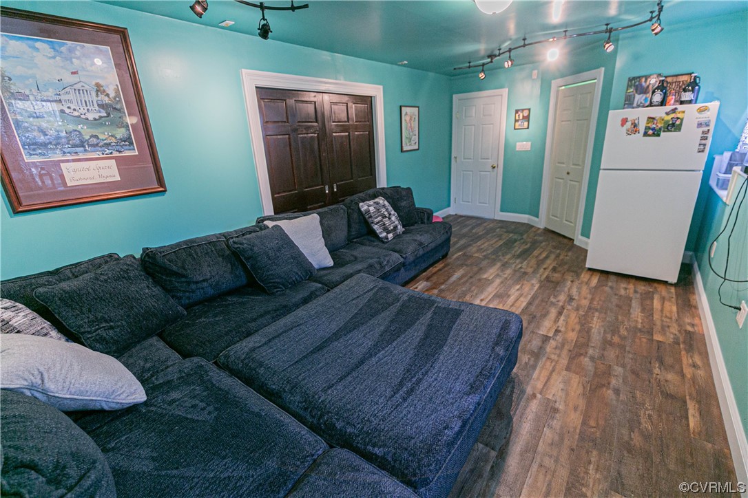 213 Cedar Ridge Drive Ruther Glen, VA 22546 - Photo 29 of 50 a living room with furniture and a wooden floor