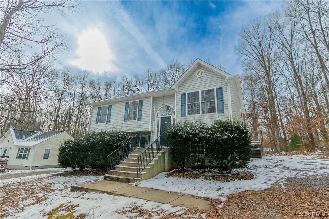 213 Cedar Ridge Drive Ruther Glen, VA 22546 - Photo 3 of 50 a front view of a house with a garden